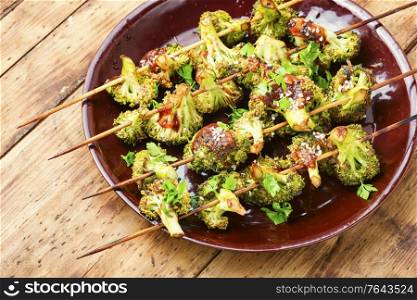 Vegetable kebab from broccoli cabbage on rustic wooden background. Kebab from broccoli cabbage