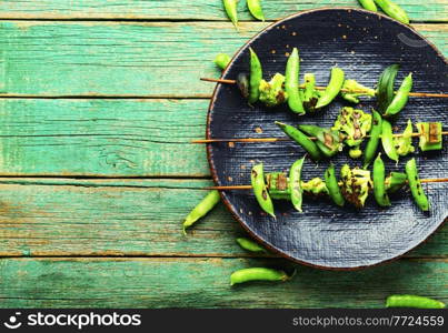 Vegetable kebab with broccoli, green peas and okra.Vegan skewer on stick.Copy space. Grilled vegetable skewers,space for text