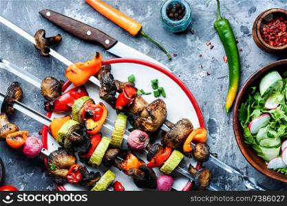 Vegetable kebabs with peppers, mushrooms, zucchini and tomatoes.Vegetarian skewers. Grilled vegetables skewers kebab