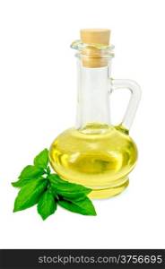 Vegetable oil in a glass carafe with basil isolated on white background