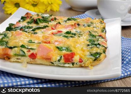 Vegetable omelet with spinach, sausage and a cup of coffee