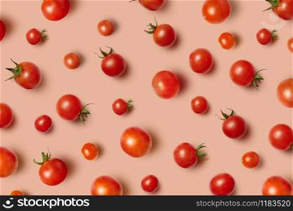 Vegetable pattern from freshly picked natural organic ripe healthy tomatoes cherry on a light beige background with soft shadows. Top view.. Juicy fresh organic tomatoes pattern with soft shadows.