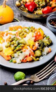 Vegetable rice risotto with pumpkin, carrots, peas and cabbage. Autumn menu.Italian risotto. Lean vegetable risotto