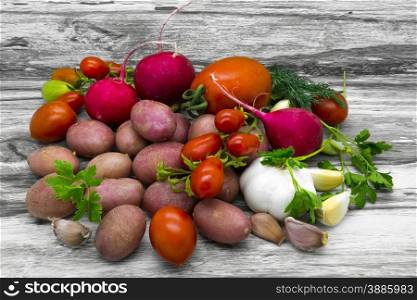 Vegetable rustic still life on a gray wooden background.