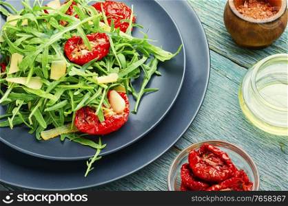 Vegetable salad of sun dried tomato and arugula.Healthy green salad. Green salad with sun dried tomato