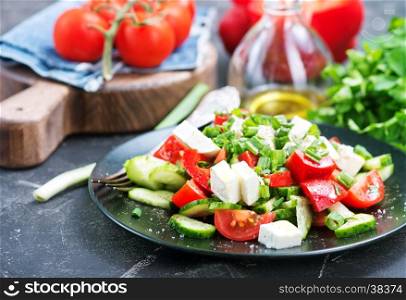 vegetable salad on black plate and on a table
