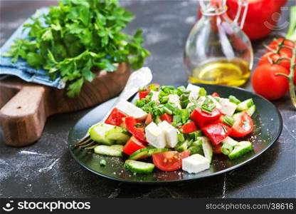 vegetable salad on black plate and on a table