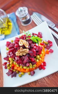 vegetable salad on plate and on a table