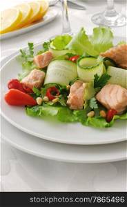 Vegetable salad with boiled salmon and pine nuts