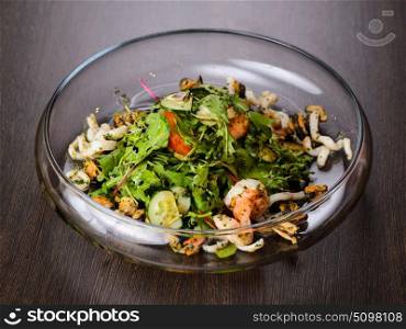 Vegetable salad with seafood on plate. Vegetable salad with seafood on plate, view from above