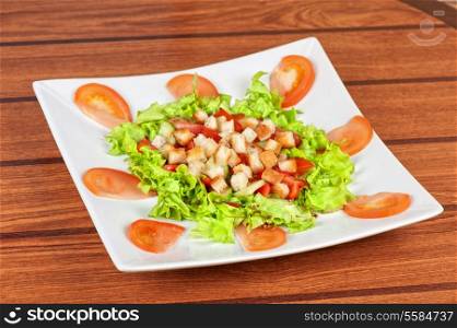 Vegetable salad with tomato, lettuce, cucumbers and crackers