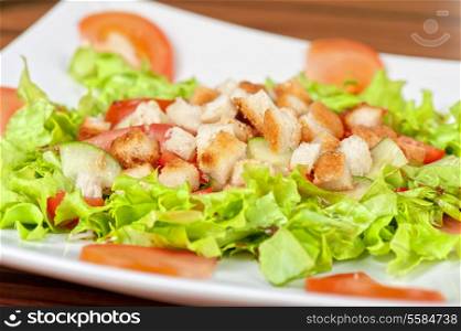 Vegetable salad with tomato, lettuce, cucumbers and crackers