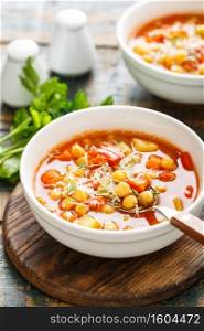 Vegetable soup bowl. Tuscan tomato chickpea soup with various vegetables, thyme and parmesan cheese.