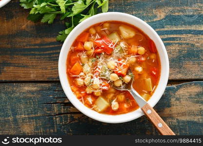 Vegetable soup bowl. Tuscan tomato chickpea soup with various vegetables, thyme and parmesan cheese.