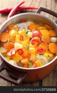 vegetable soup in red pot