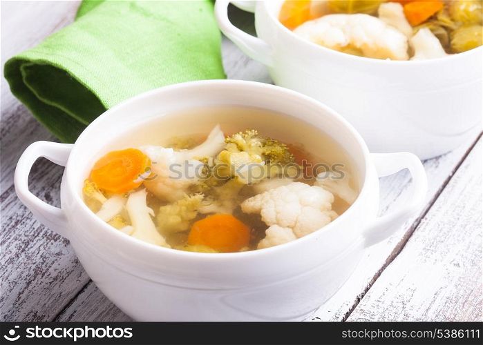 Vegetable soup in white bowl close up on the table