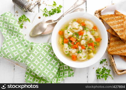 Vegetable soup with cauliflower, carrot, green peas, onion and potato