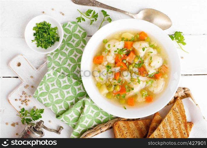 Vegetable soup with cauliflower, carrot, green peas, onion and potato