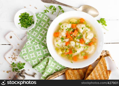 Vegetable soup with cauliflower, carrot, green peas, onion and potato