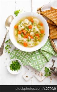 Vegetable soup with cauliflower, carrot, green peas, onion and potato
