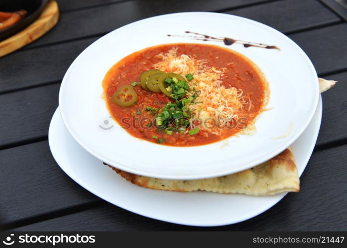 vegetable soup with cheese in white dish