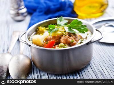 vegetable soup with meatballs in metal bowl