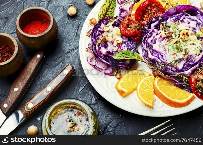 Vegetable steak from red cabbage baked with orange and hazelnuts.Vegetarian food. Baked red cabbage with hazelnuts