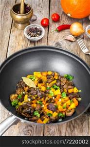 Vegetable stew with pumpkin, celery and mushrooms. Studio Photo. Vegetable stew with pumpkin, celery and mushrooms
