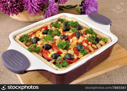 Vegetable tart with olives in a cauldron