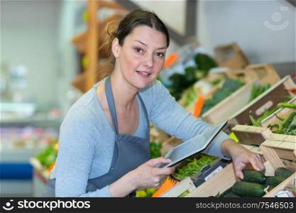 vegetable vendor using a tablet
