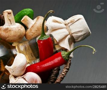 vegetables and a basket with a bottle of vinegar
