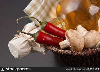 vegetables and a basket with a bottle of vinegar