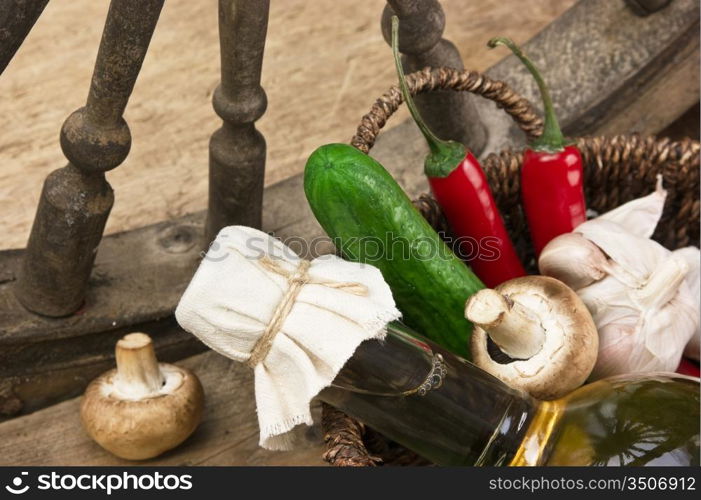 vegetables and a bottle of cooking oil in a basket