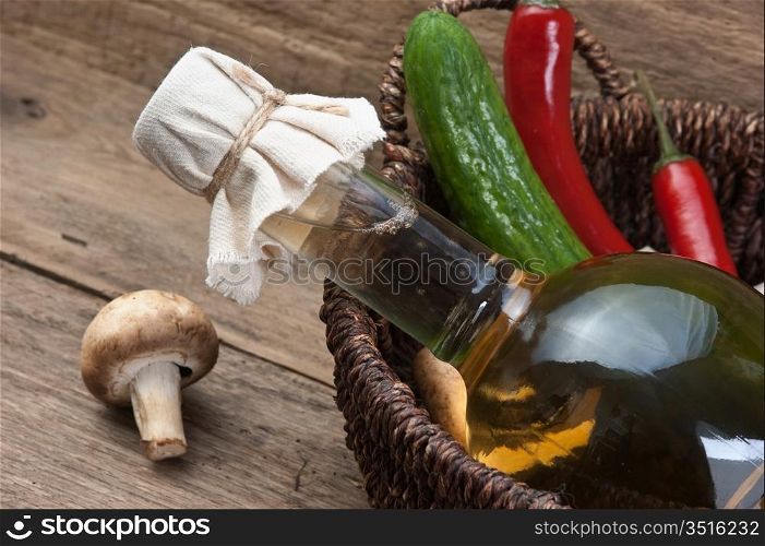 vegetables and a bottle of cooking oil in a basket