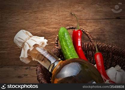 vegetables and a bottle of cooking oil in a basket