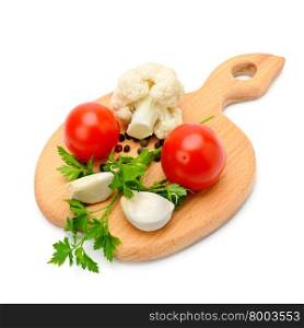 vegetables and spices on the kitchen board isolated on white background