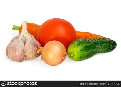 Vegetables composition (carrot, cucumber, garlic, onion, tomato) isolated on white.