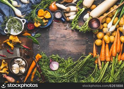 Vegetables cooking ingredients for tasty vegetarian dishes. Carrot , potato , onion , mushrooms , garlic , thyme , parsley on dark rustic wooden background, frame