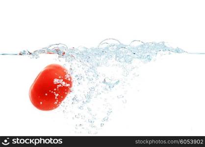 vegetables, food and healthy eating concept - close up of fresh red tomato falling or dipping in water with splash over white background