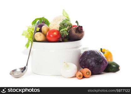Vegetables for soup in pan isolated on white. Vegetables for soup