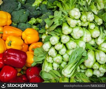 Vegetables in Asian market close up - Capsicum bell peppers, broccoli cabbage, Green chinese cabbage