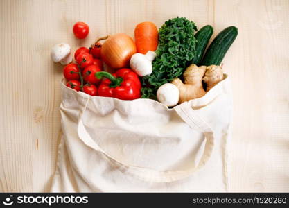 Vegetables in cloth bag on light wooden background. food bag and eco-friendly concept. Healthy food background.