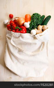 Vegetables in cloth bag on light wooden background. food bag and eco-friendly concept. Healthy food background.