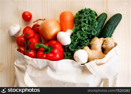 Vegetables in cloth bag on light wooden background. food bag and eco-friendly concept. Healthy food background.