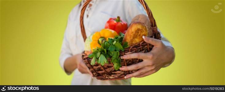 Vegetables in hands. Unrecognizable woman holding basket full of natural organic food