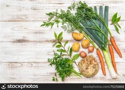 Vegetables mix for preparation of soup. Leek, carrots, onion, parsley, potatoes, celery root, bay laurel leaves. Healthy food. Fresh organic nutrition