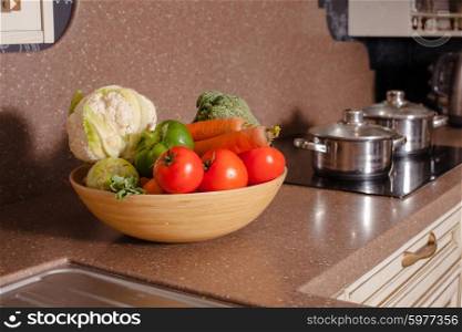 Vegetables near the casseroles in the kitchen, cooking concept