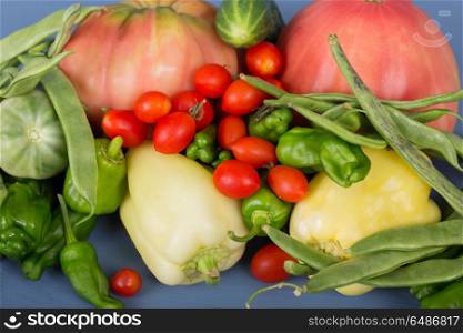 vegetables on a blue wooden surface. vegetables