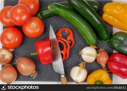 vegetables on a cutting plate with a kitchen knife
