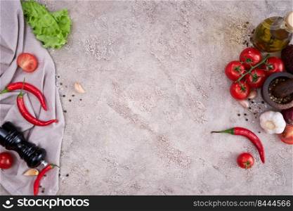 Vegetables On grey stone concrete table top view with copy space - chili pepper, tomato, garlic, olive oil.. Vegetables On grey stone concrete table top view with copy space - chili pepper, tomato, garlic, olive oil
